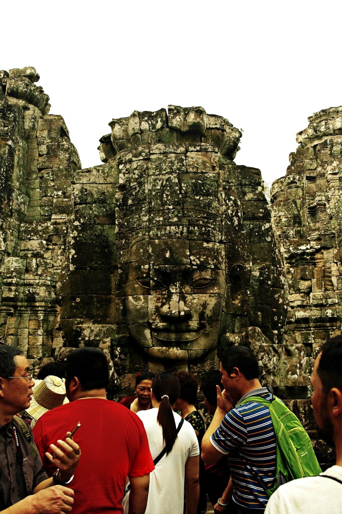 people and human face statue in sieam reap angkor wat temple